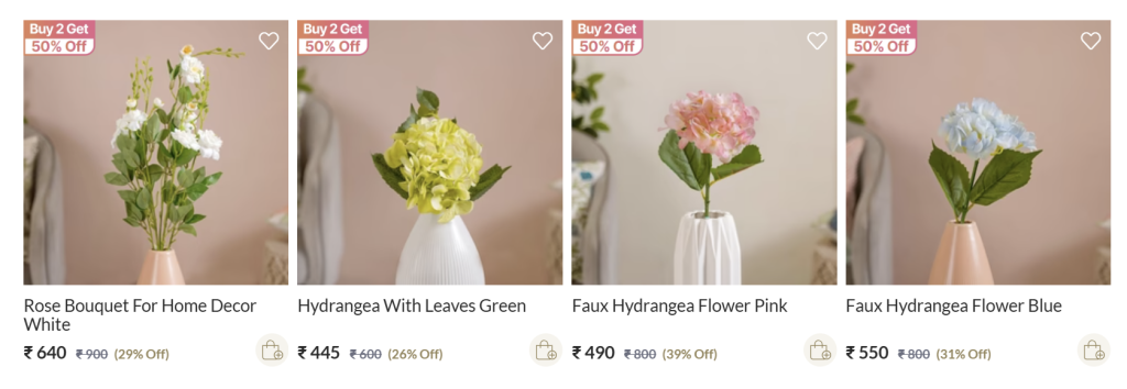 Four product listings with “Buy 2 Get 50% Off” badges displayed above floral home decor items