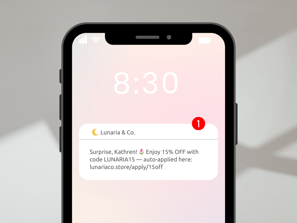 sms-marketing-example - Advanced Coupons Phone screen showing an SMS message from Lunaria & Co. offering 15% off with code LUNARIA15 and a link to auto-apply the coupon.