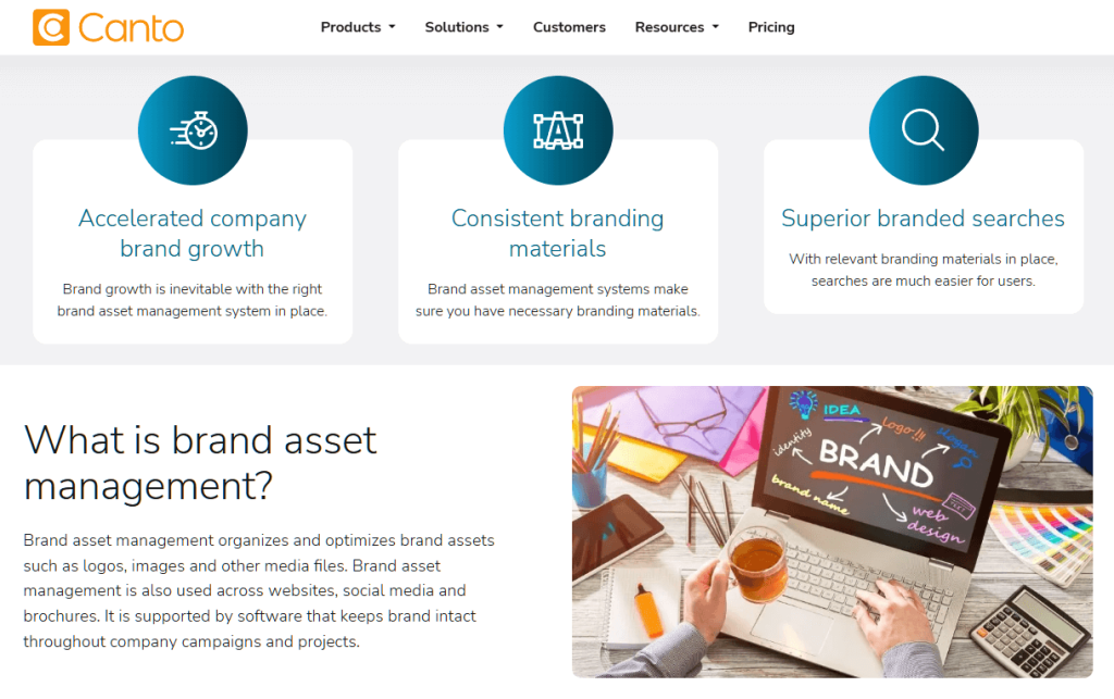 Website screenshot of Canto explaining brand asset management with three feature panels and explanatory text alongside an office desk photo with laptop.